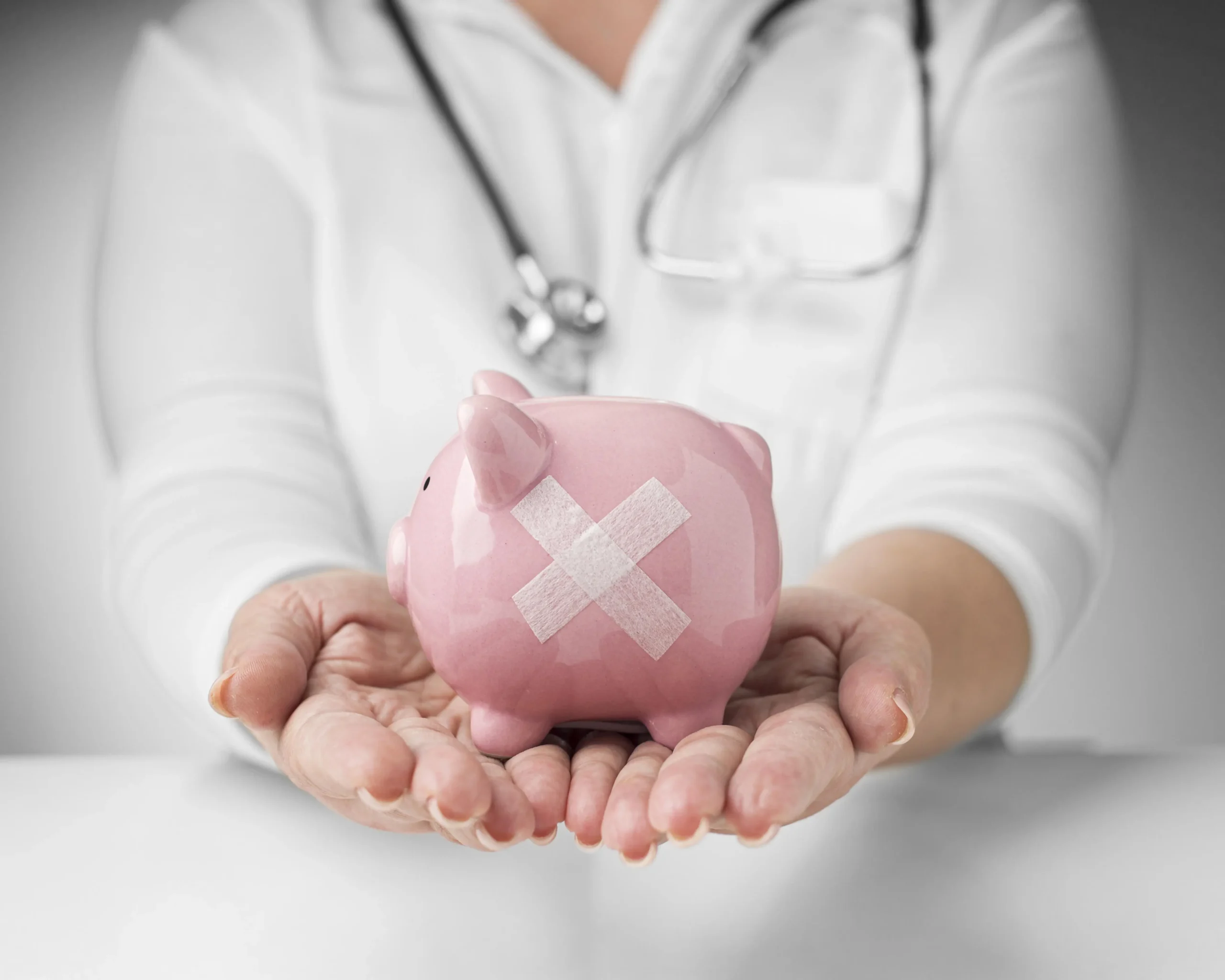 person-holding-piggy-bank-with-band-aids